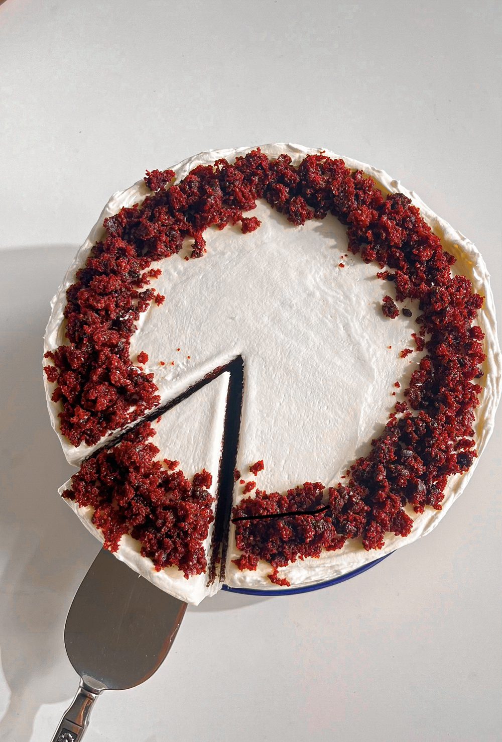 Eggless red velvet cake with creamy frosting and soft velvet crumb