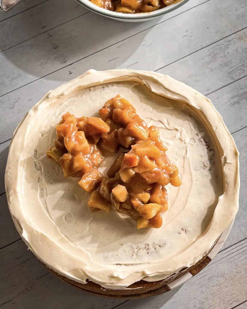 Apple pie filling layered between cinnamon cake layers